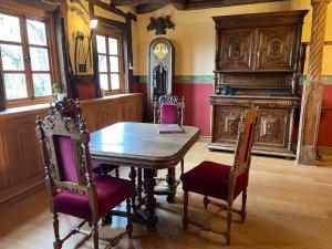 a dining room with a wooden table and chairs at Klausenhof in Bornhagen