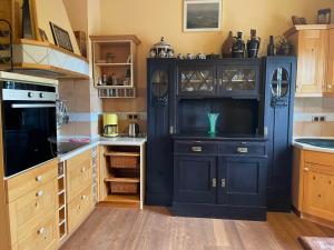 a kitchen with a black cabinet in a kitchen at Klausenhof in Bornhagen