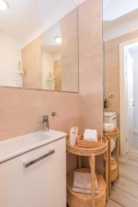 a bathroom with a sink and a mirror at LuxArt City Spa Gallery Residence Krk in Krk