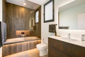 a bathroom with a tub and a toilet and a sink at Casa Jolie in Ponta do Sol +23 photos