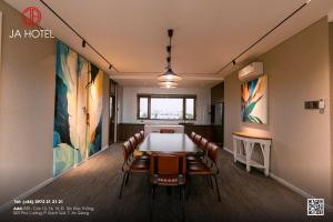a conference room with a long table and chairs at JA Hotel in Ấp Rạch Mẹo +76 photos