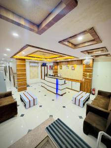 Una sala de estar con sofás y una mesa. en Hotel Manish International, en Kashi