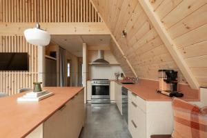 an attic kitchen with a vaulted ceiling and wooden counters at Canadian Classic - Spa - Sauna - Fire - Forest in Val-David