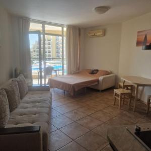 a living room with a bed and a couch at Charming Studio at the Seaside in Aheloy