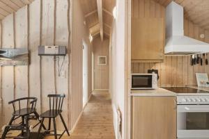 a kitchen with a counter and two chairs in it at M397-Vaeggerlose-Stolt-Henriksvej-111 in Marielyst