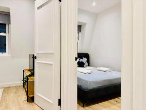 a small bedroom with a bed and a door at Old Compton Apartments in London