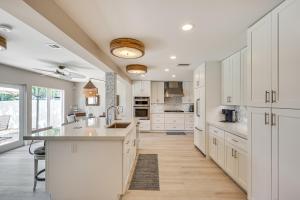 a kitchen with white cabinets and a large island at Spacious Yard, Near Golf Modern Home in Hollywood in Hollywood Beach