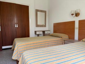 a hotel room with two beds and a mirror at Holiday Home Villa Guapa in L'Estartit +39 photos