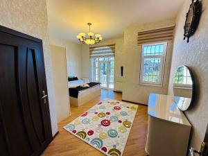 a living room with a bed and a rug at Quba Village Villa in Quba