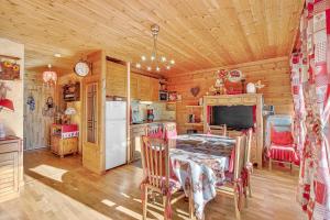 a dining room with a table and a refrigerator at Cosy Et Lumineux À Montclar Alpes in Montclar +29 photos