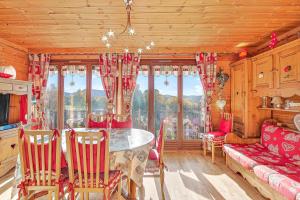 a dining room with a table and chairs and a window at Cosy Et Lumineux À Montclar Alpes in Montclar