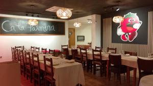 a dining room with tables and chairs and a chalkboard at Hostal Cabrerès in Cantonigros +67 photos