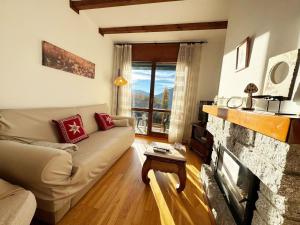 a living room with a couch and a fireplace at C19 - Bellavista Pirineo - Villmor in Cerler