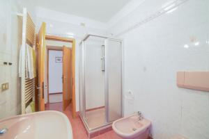 a bathroom with a sink and a shower and a toilet at Casa Defrancesco - with terrace in Moena +36 photos