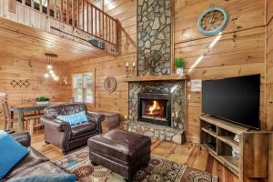 a living room with a fireplace and a television at Among The Trees in Vilas