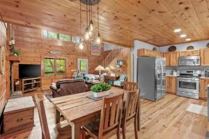 a kitchen and living room with a table and a dining room at Among The Trees in Vilas