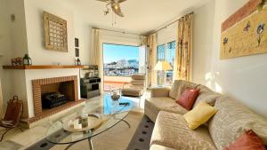 a living room with a couch and a fireplace at Villa Jazmin in Nerja