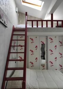 a bedroom with a bunk bed with a ladder at Chambres d'hôtes - Les Orchidées in Perpignan