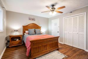 a bedroom with a bed and a ceiling fan at Chatuge Fish Retreat in Hiawassee