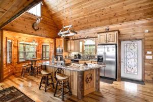 a kitchen with a large center island in a log cabin at Blue View Mountain in Murphy