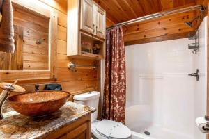 a bathroom with a sink and a toilet and a shower at Blue View Mountain in Murphy +104 photos