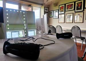 a conference room with a table with a phone on it at Nine Yards Bell Tents - Lytham in Lytham St Annes