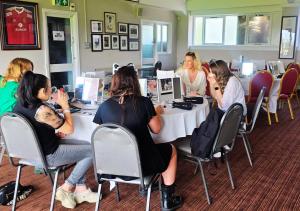 a group of women sitting at a table in a room at Nine Yards Bell Tents - Lytham in Lytham St Annes