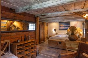 een slaapkamer met houten wanden en een bed en een tafel bij Chalet authentique luxe piscine in Les Contamines-Montjoie