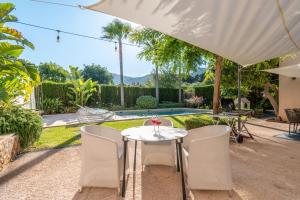 un patio avec une table et des chaises et une piscine dans l'établissement Ca Na Maronja, à Pollença