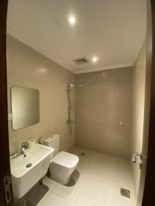 a bathroom with a white toilet and a sink at جوهرة الياقوت in Jeddah