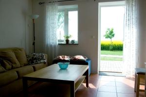 a living room with a couch and a coffee table at Skönadal B&B in Gislöv