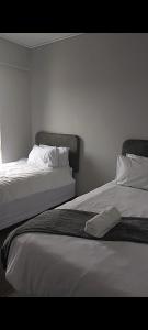 two beds sitting next to each other in a room at The Eyrie in Nelspruit +7 photos