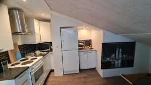a kitchen with a white refrigerator and a stove at Ugglegatan 17 - Två rum & kök in Linköping