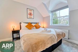 a bedroom with a bed with a doll on it at Central and Stylish, Garden and Parking in Coventry