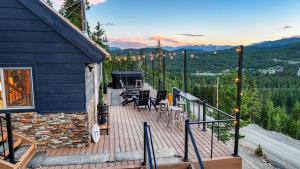 a deck with chairs and tables on top of a house at Skyline Lodge in Ninetyfour