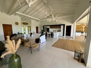 a living room with a couch and a table at Villa Cokoon in Saint-François
