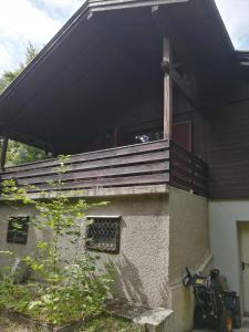 a house with a porch with a balcony at Ferienhaus am Waxeneck in Feichtenbach +5 photos