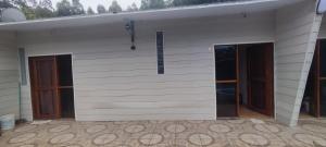 a building with three doors on the side of it at cabañas en cuchilla alta in Cuchilla Alta +16 photos