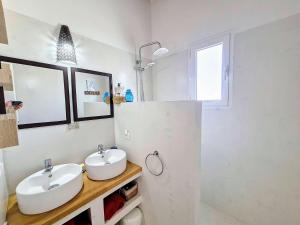 Agios AimillianosにあるJolie villa proche des plagesの洗面台と鏡のある白いバスルーム +21枚の写真