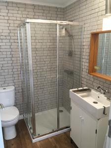 a bathroom with a shower and a toilet and a sink at Casa Do Canto in Cascais
