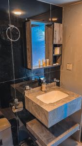 a bathroom with a sink and a window at RUM FLORAA LUXURY CAMp in Wadi Rum