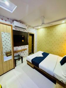 Ένα ή περισσότερα κρεβάτια σε δωμάτιο στο Hotel Manish International