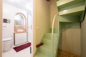 a bathroom with green stairs and a sink and a toilet at Maison Noir Napoli in Naples +35 photos