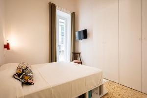 a bedroom with a bed and a window at Maison Noir Napoli in Naples
