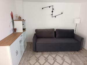 a living room with a couch and a table at Casuta argeseana in Oeștii Ungureni