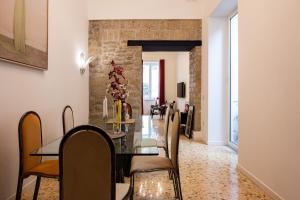 a dining room with a table and chairs at Maison Noir Napoli in Naples
