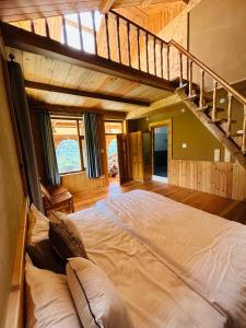 a large bed in a room with a staircase at Himalayan Baseraa in Sainj