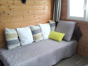 a bed with a bunch of pillows on it at Chaletdelachapelle Zoo 4km in Noyers-sur-Cher