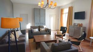 a living room with couches and chairs and a table at Les Flamants in Portiragnes