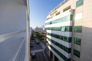 a view of a tall building with a parking lot at Élégant 2BR au cœur de Hassan by MERAT HOME in Rabat